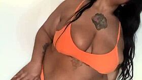 This ebony milf in a bikini dances, shaking her big tits and ass