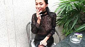 is that young girl smoking topless in leather?