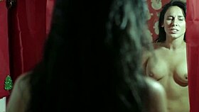 Two sexy brunettes bathe in underwear on the bed during christmas