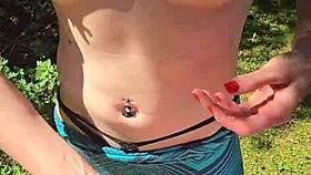 Wife gives quick handjob with pierced nipples while out on a public walk