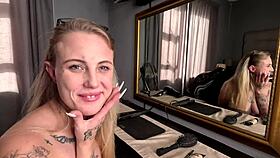 Sexy tattooed blonde girl does her hair and makeup naked