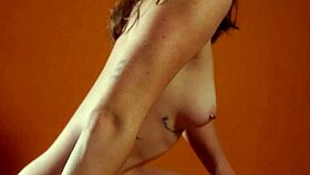 Big ass babe poses naked with pierced nipples and small tits