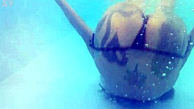 Melissa the mermaid with tattoo in pool