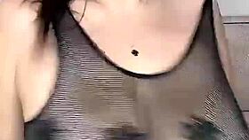 She fucks those huge natural tits in stockings on the mesh!