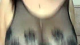 She fucks those huge natural tits in stockings on the mesh!