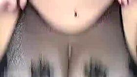 She fucks those huge natural tits in stockings on the mesh!