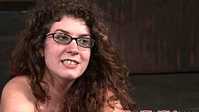 BDSM sub with big tits gagging on dildo in bondage session