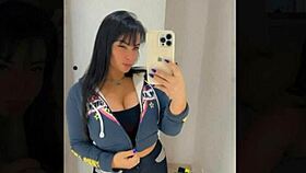 Beautiful brunette tries outfits in public store fitting room