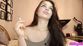 Xo bunny, the brunette Latina with blue eyes, smokes and blows smoke in your face