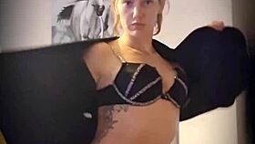 Blonde woman undresses with clothes ripped in teasing striptease