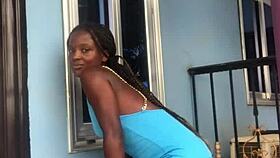 A crazy woman twerks wildly on the balcony under the open sky