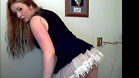 Watch the redheaded tease strip seductively