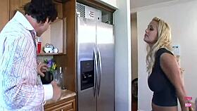 a blonde lady with big fake tits fucks in kitchen