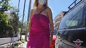 hey, check out this kinky babe flashing pierced nipples and ass on street?