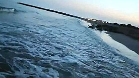 Blonde shows tits and sucks cock on a public beach