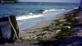 Big tits brunette sensual babe jane masturbates by fingering her pierced pussy on the outdoor beach