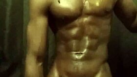 He's stroking his big black cock with loads of oil