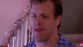 During Christmas, blonde babe with big fake juggs gets drilled by a hung stud.