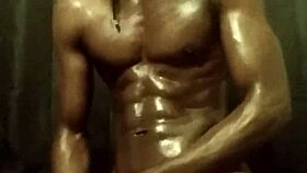 He's stroking his big black cock with loads of oil