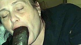 mature woman passionately performs oral on her lover in the bedroom