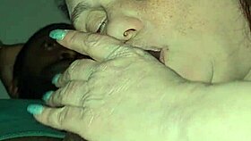 mature woman passionately performs oral on her lover in the bedroom