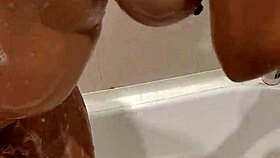 naked woman standing in the shower under the water