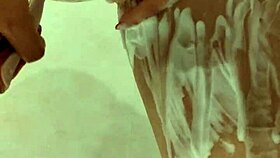 naked woman standing in the shower under the water