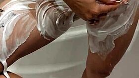 naked woman standing in the shower under the water