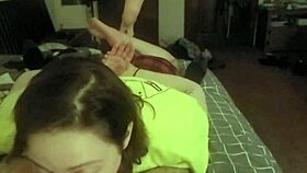 Laying on her stomach and deepthroating the slave's cock