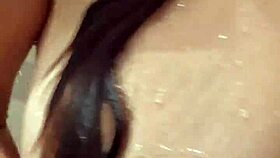 naked woman standing in the shower under the water