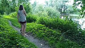 Two girls pee golden rain by the road