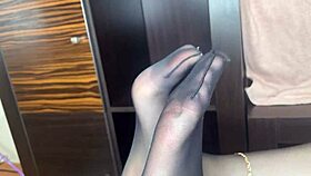 closeup foot in black stockings teases anal bed play