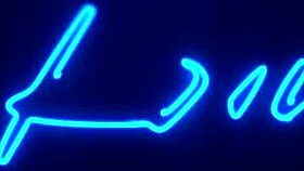 the blonde girl gets helped by someone and then receives a drink in her mouth