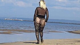Beautiful milf in black style flashes big tits and ass on the beach