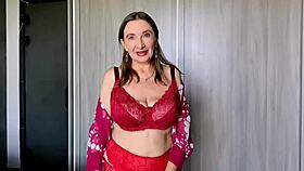 That granny in red lingerie and stockings teases with huge tits and dirty talk