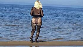 Beautiful milf in black style flashes big tits and ass on the beach