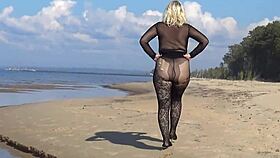 Beautiful milf in black style flashes big tits and ass on the beach