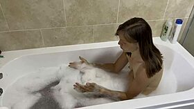 brunette milf sings naked in the bath, revealing hairy pussy