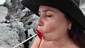 watch the brunette milf practice sucking on the beach