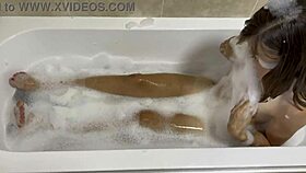brunette milf sings naked in the bath, revealing hairy pussy
