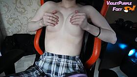 young woman plays with her nipples when she is home alone