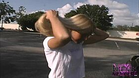 Tanned blonde flashes shaved pussy and natural tits in public park tease