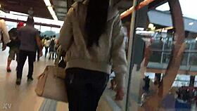 woman in jacket and boots rides train candidly