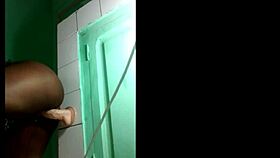 black gymnast fixes wall dildo for acrobatic lesbian toy play session