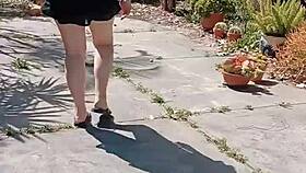 Mature blonde spreads big shaved pussy in garden