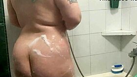 Chubby tattooed babe showers teasing her curves and wet skin beautifully