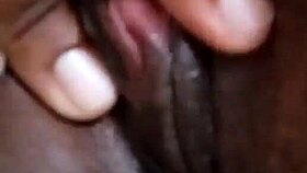 She spreads her wet ebony pussy wide fingering deeply in solo play on bed