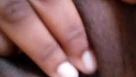 She spreads her wet ebony pussy wide fingering deeply in solo play on bed